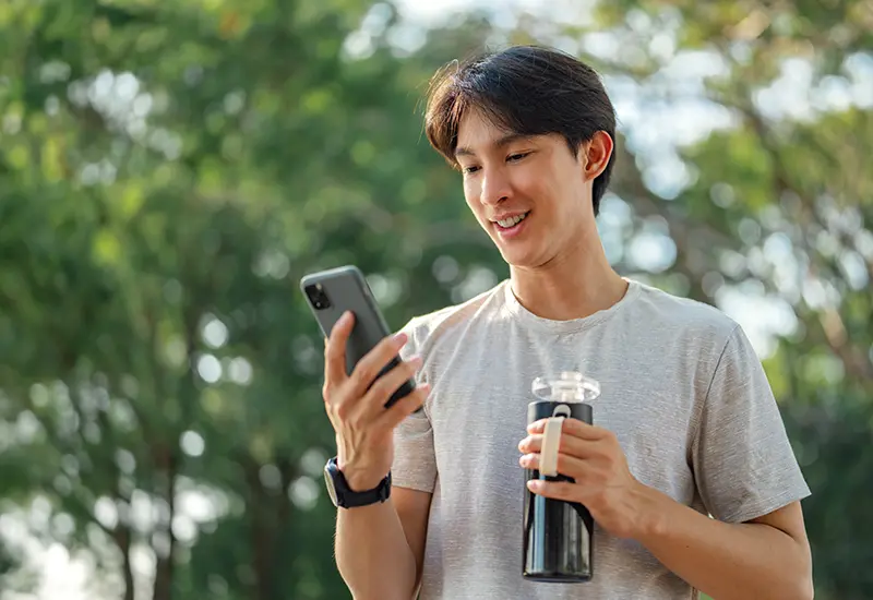 man with phone and water bottle